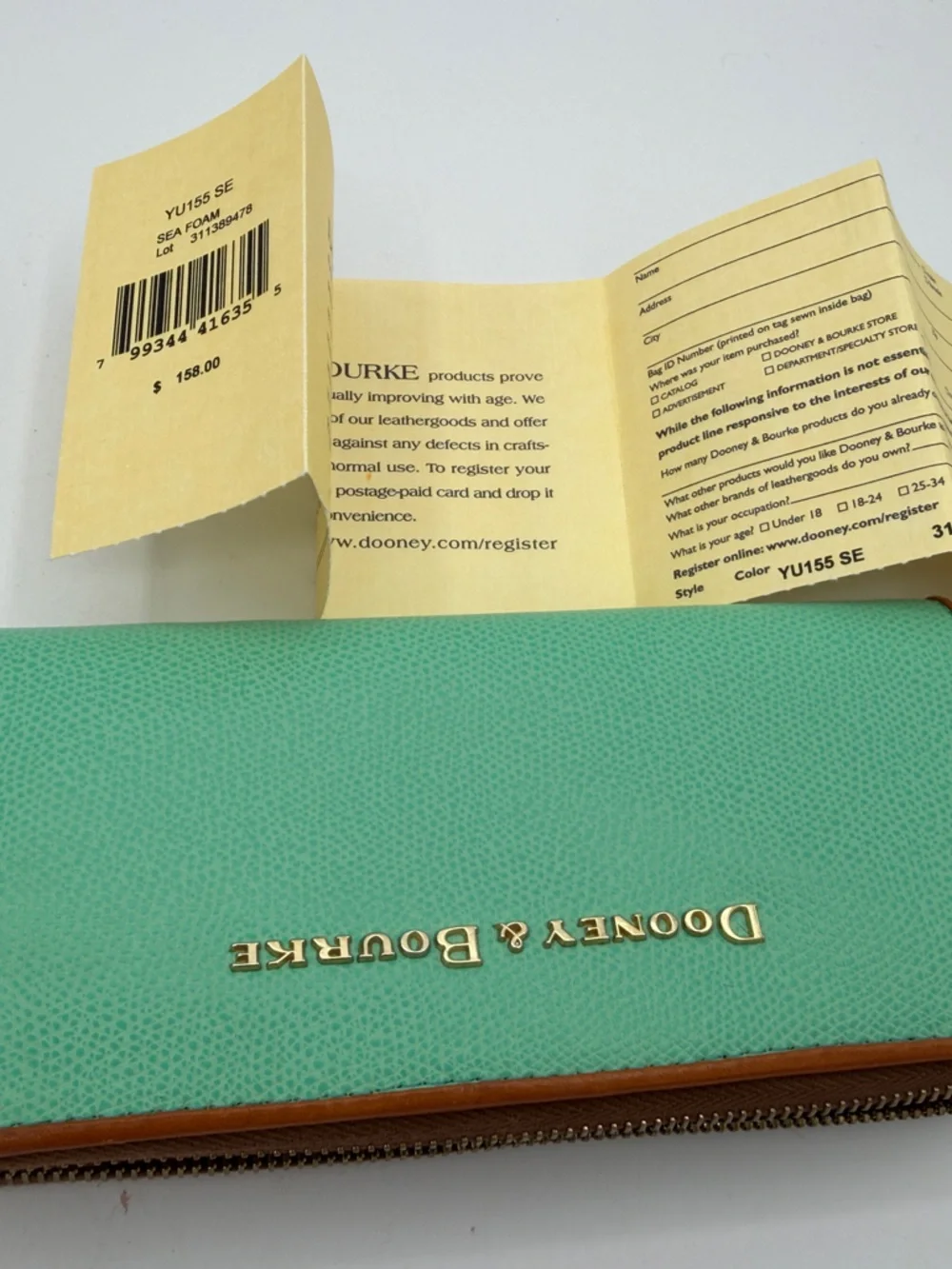 Dooney & Bourke Turquoise Zip-Around Wallet with Tan Trim and Gold Logo